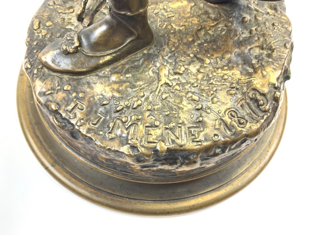 A dark brown patinated bronze sculpture depicting an Arab falconer holding a falcon overhead while standing on a circular base. View VI