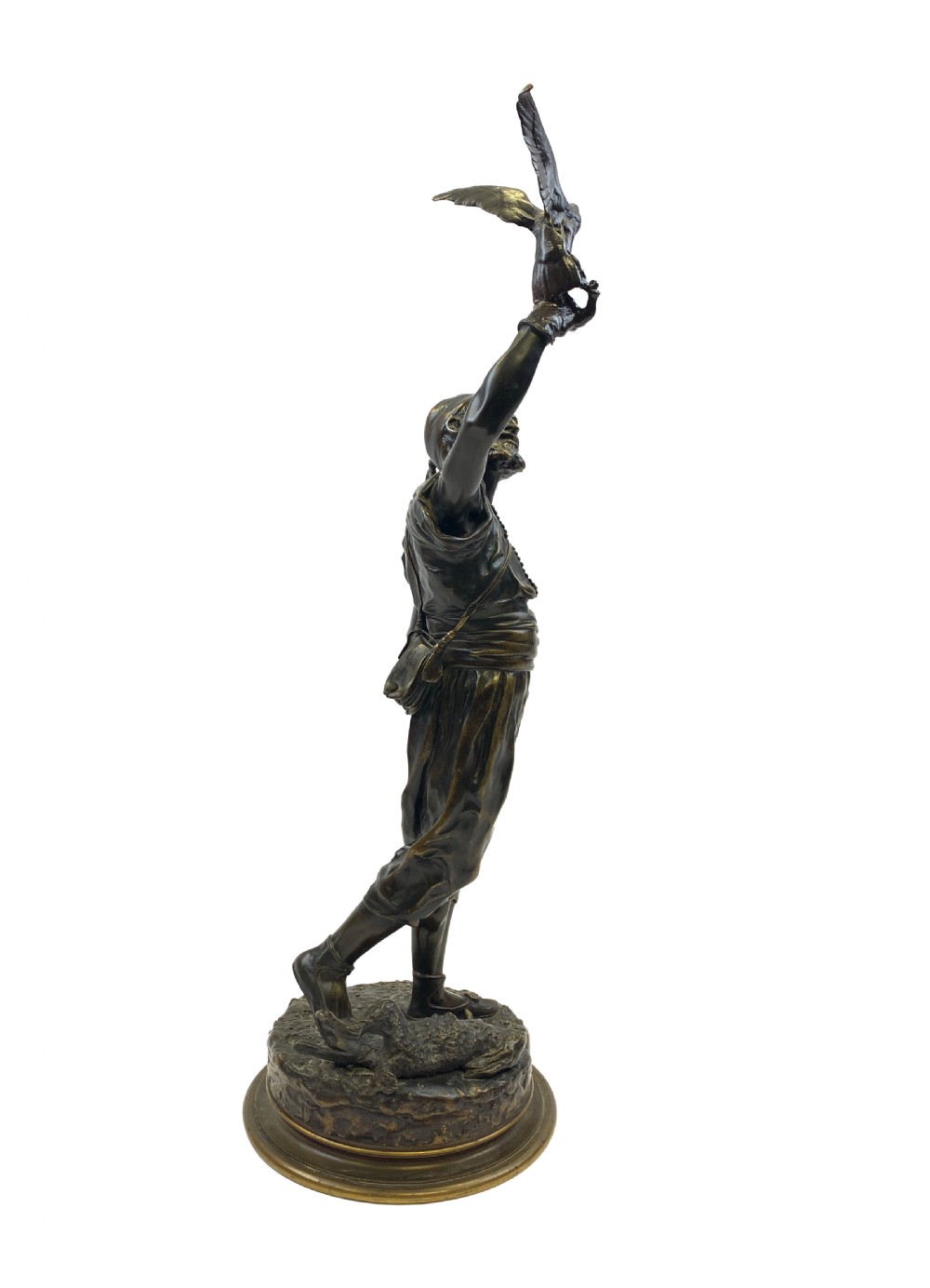 A dark brown patinated bronze sculpture depicting an Arab falconer holding a falcon overhead while standing on a circular base. View VII