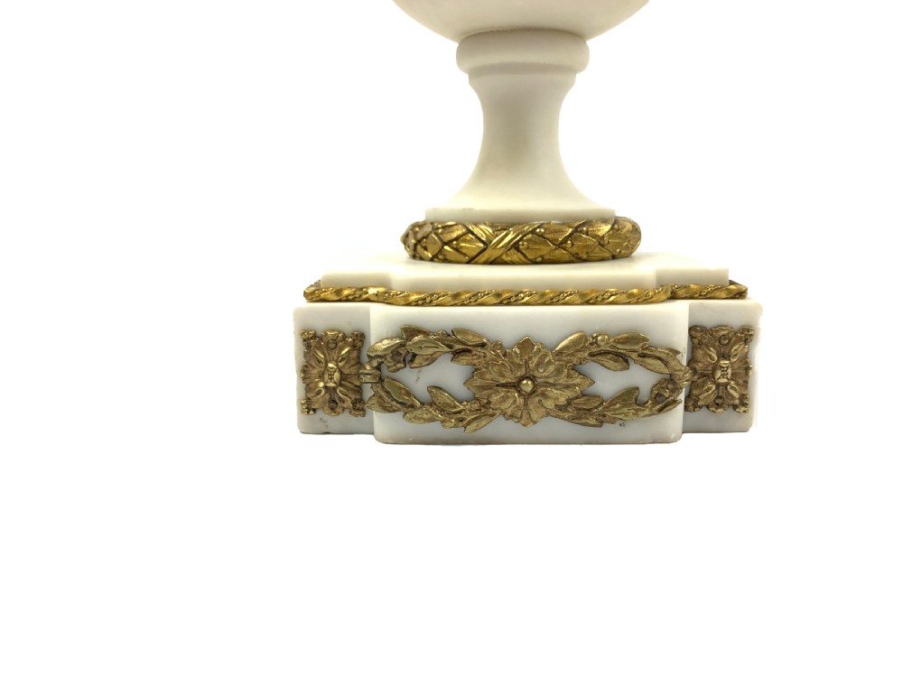 A pair of French Louis XVI style white marble urn candelabra with gilt-bronze rose foliage branches and ribbon mounts. View II