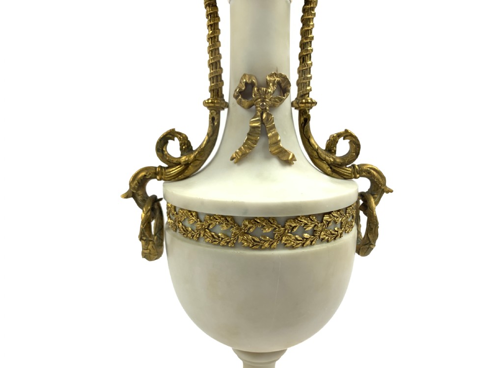 A pair of French Louis XVI style white marble urn candelabra with gilt-bronze rose foliage branches and ribbon mounts. View III
