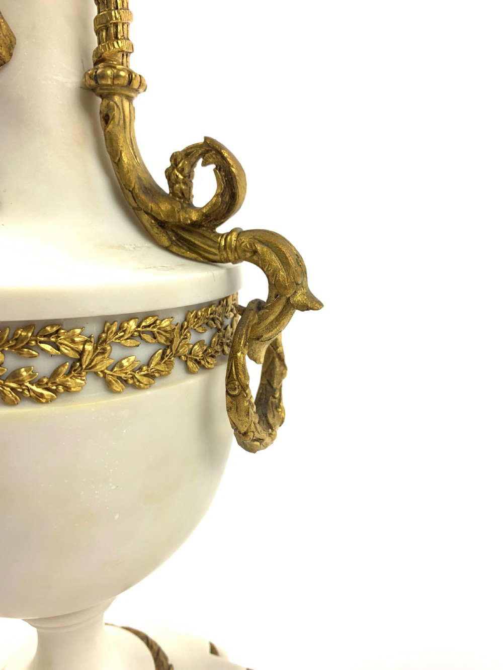 A pair of French Louis XVI style white marble urn candelabra with gilt-bronze rose foliage branches and ribbon mounts. View V