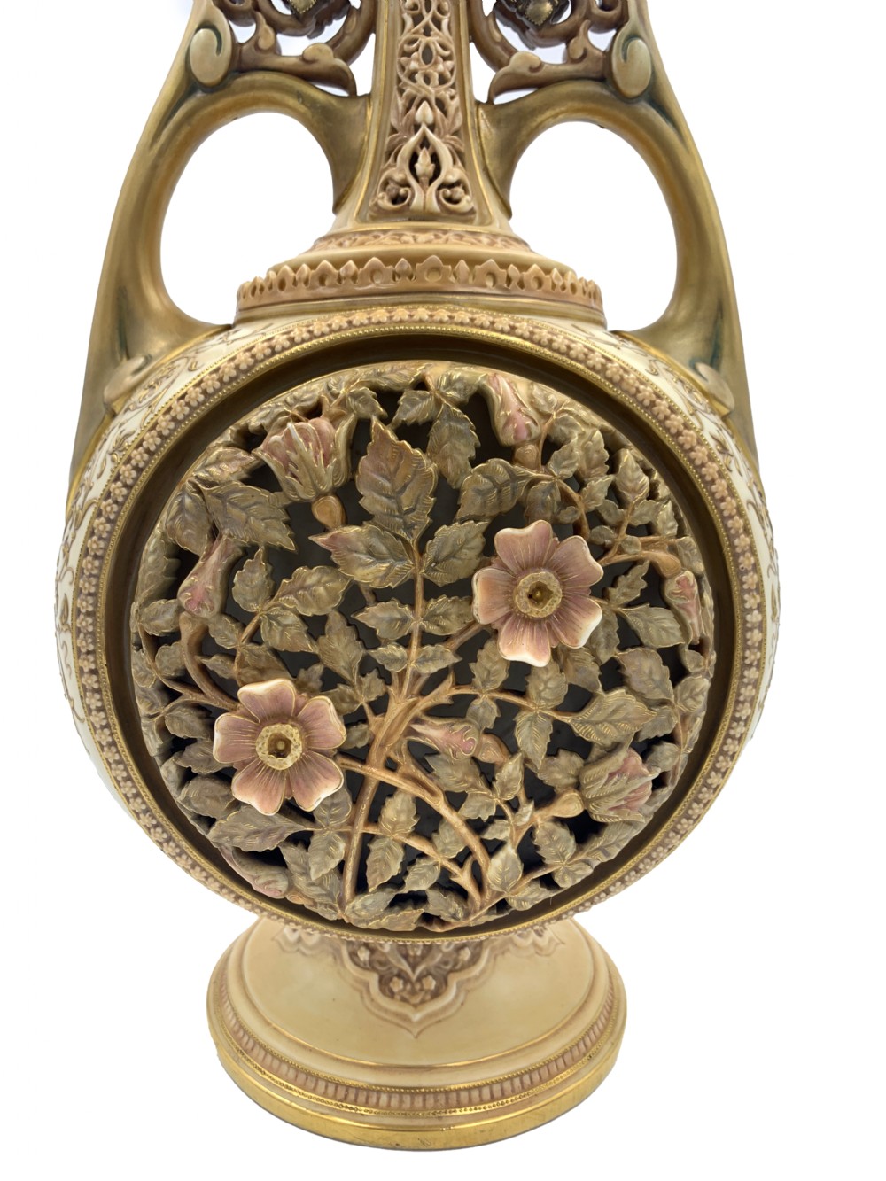 A late 19th-century Royal Worcester porcelain vase featuring twin handles, pierced reticulated panels, gilt accenting, and relief floral decoration on a blush ivory surface. View VI