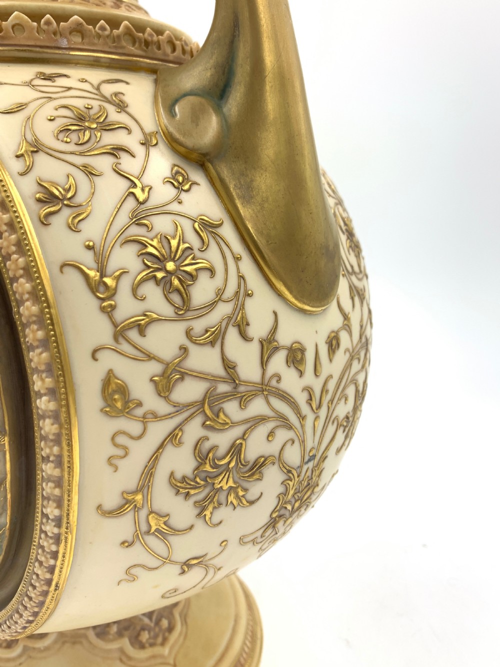 A late 19th-century Royal Worcester porcelain vase featuring twin handles, pierced reticulated panels, gilt accenting, and relief floral decoration on a blush ivory surface. View IX