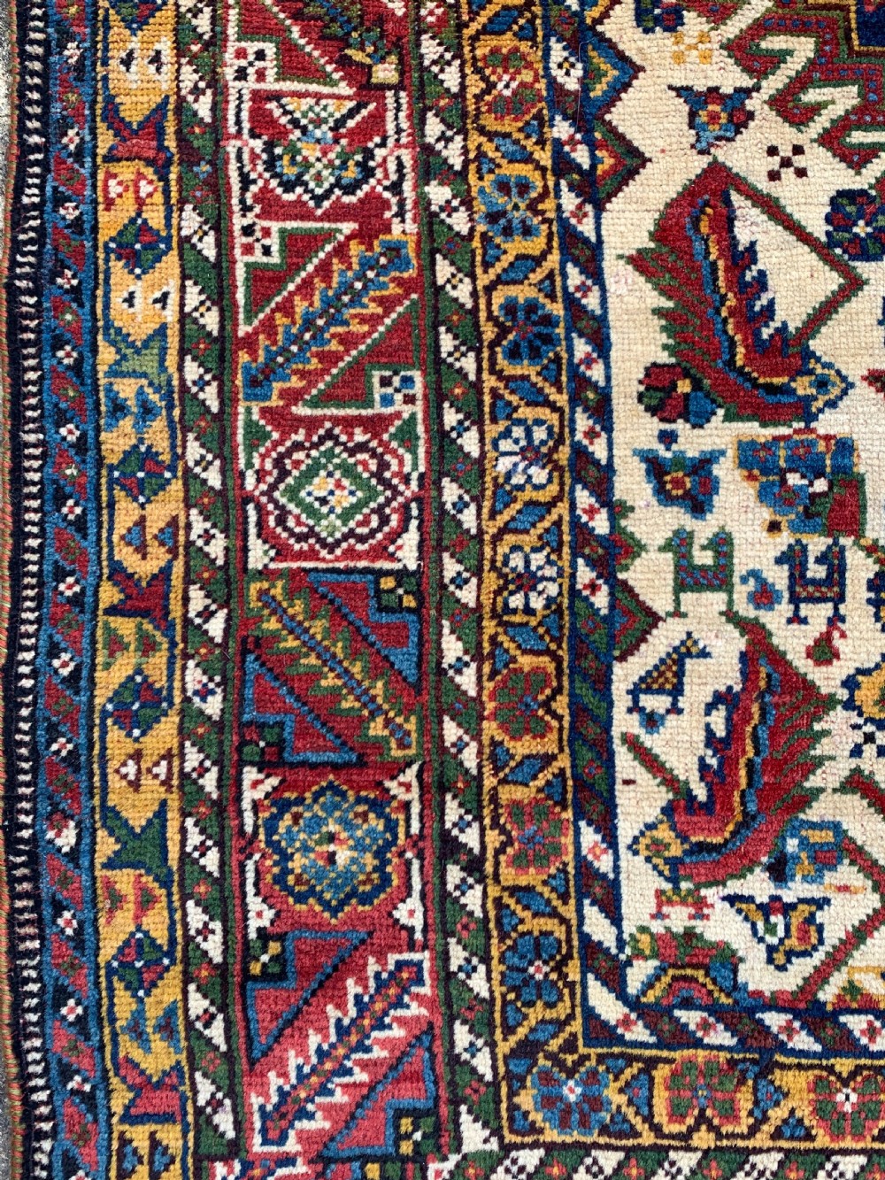 An antique Persian Qashqai hand-knotted wool rug featuring geometric diamond medallions on a navy blue tribal field with intricate multi-tiered borders. View VIII