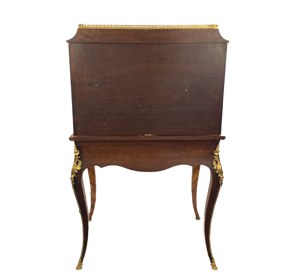 A late 19th-century French kingwood bonheur du jour featuring parquetry veneers, gilt-bronze mounts, oval porcelain plaques, and curved cabriole legs. View III