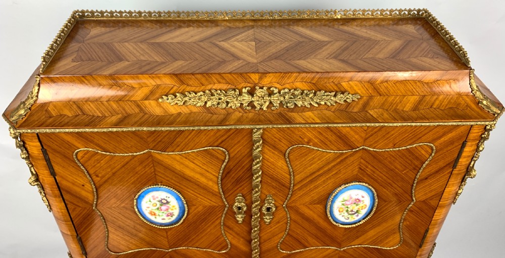 A late 19th-century French kingwood bonheur du jour featuring parquetry veneers, gilt-bronze mounts, oval porcelain plaques, and curved cabriole legs. View VI