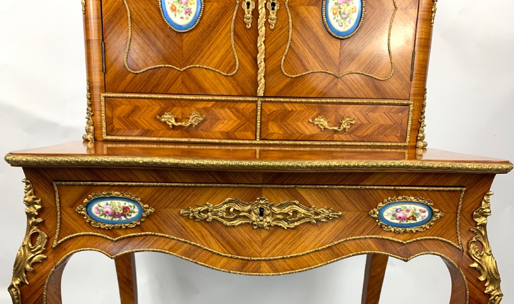 A late 19th-century French kingwood bonheur du jour featuring parquetry veneers, gilt-bronze mounts, oval porcelain plaques, and curved cabriole legs. View VII