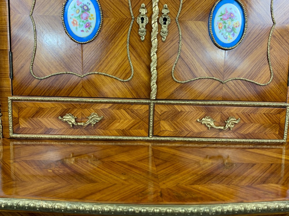 A late 19th-century French kingwood bonheur du jour featuring parquetry veneers, gilt-bronze mounts, oval porcelain plaques, and curved cabriole legs. View XI
