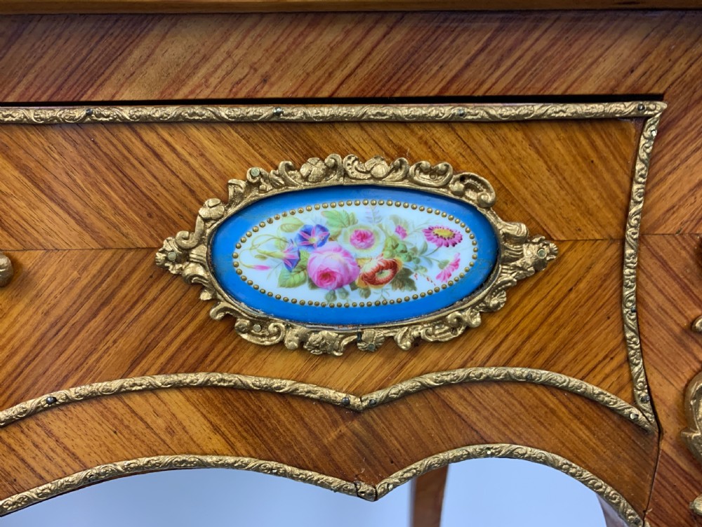 A late 19th-century French kingwood bonheur du jour featuring parquetry veneers, gilt-bronze mounts, oval porcelain plaques, and curved cabriole legs. View XIII