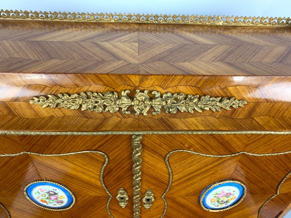 A late 19th-century French kingwood bonheur du jour featuring parquetry veneers, gilt-bronze mounts, oval porcelain plaques, and curved cabriole legs. View XV