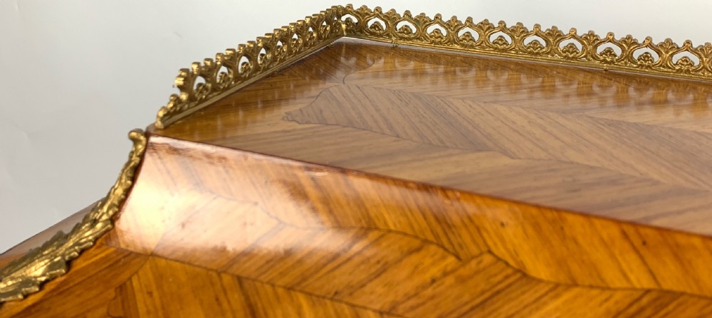A late 19th-century French kingwood bonheur du jour featuring parquetry veneers, gilt-bronze mounts, oval porcelain plaques, and curved cabriole legs. View XVI
