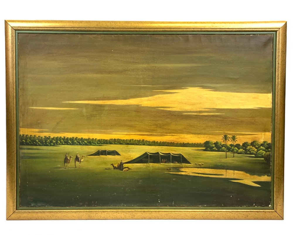 An oil painting on canvas depicting a desert landscape with camels, Bedouin tents, and palm trees under a golden sky, set within a gilded frame.
