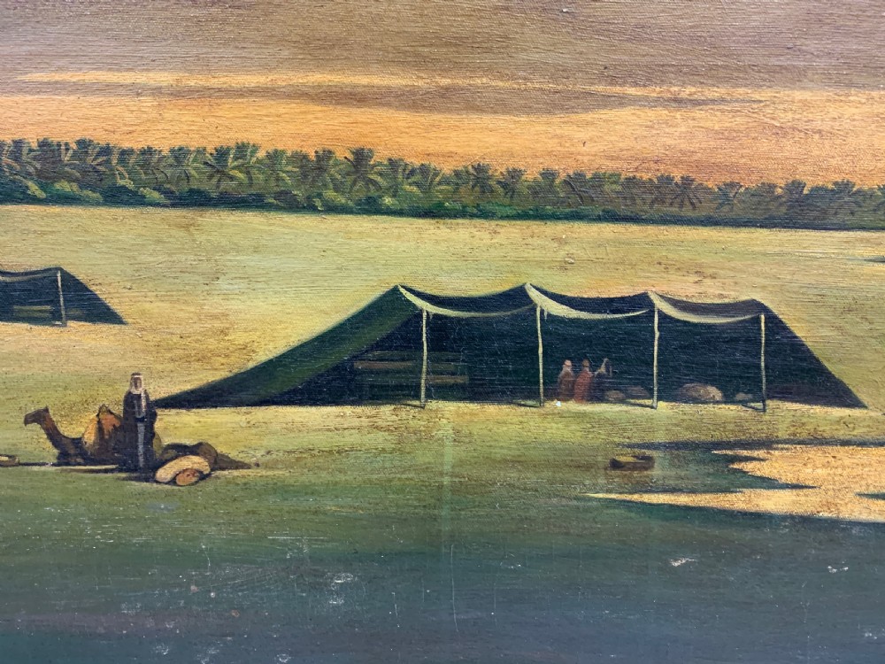 An oil painting on canvas depicting a desert landscape with camels, Bedouin tents, and palm trees under a golden sky, set within a gilded frame. View IV