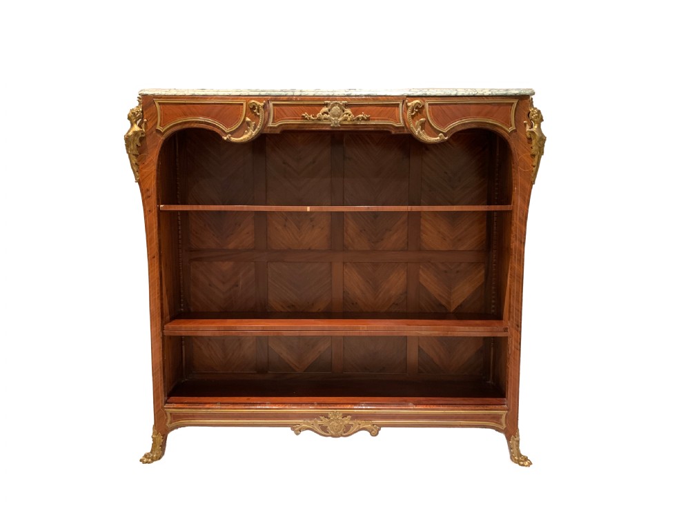 A French Louis XV style low open kingwood bookcase with parquetry backing, two shelves, gilt-bronze mounts, and a marble top.