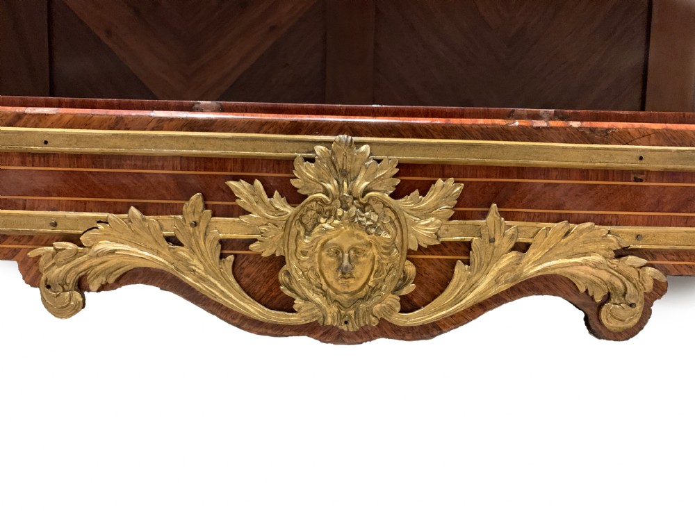 A French Louis XV style low open kingwood bookcase with parquetry backing, two shelves, gilt-bronze mounts, and a marble top. View VI