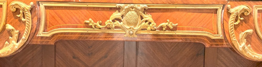 A French Louis XV style low open kingwood bookcase with parquetry backing, two shelves, gilt-bronze mounts, and a marble top. View VIII