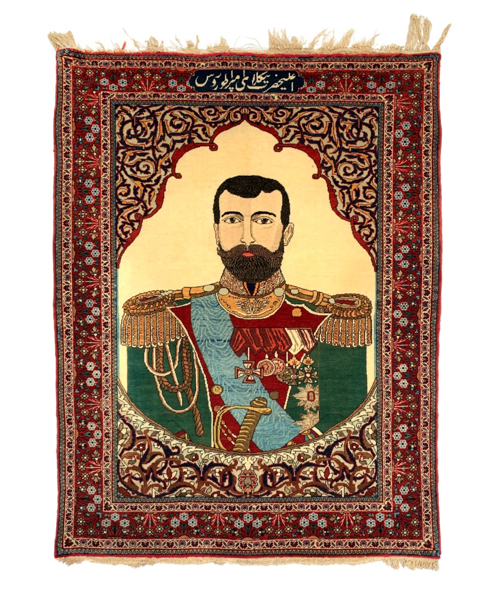 A hand-knotted antique Persian pictorial rug depicting Tsar Nicholas II of Russia in military uniform, framed by a cream archway and a dark red floral border with Persian script.
