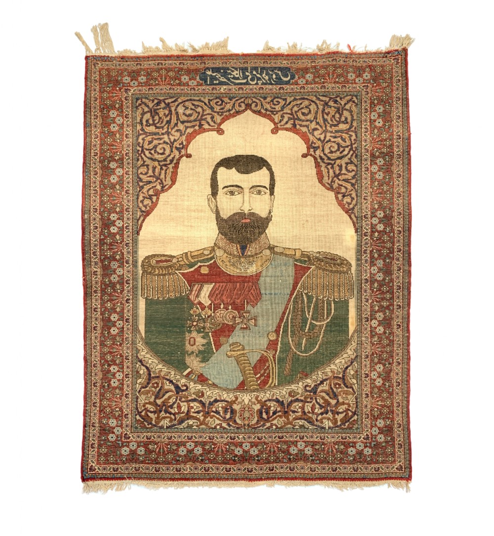 A hand-knotted antique Persian pictorial rug depicting Tsar Nicholas II of Russia in military uniform, framed by a cream archway and a dark red floral border with Persian script. View II