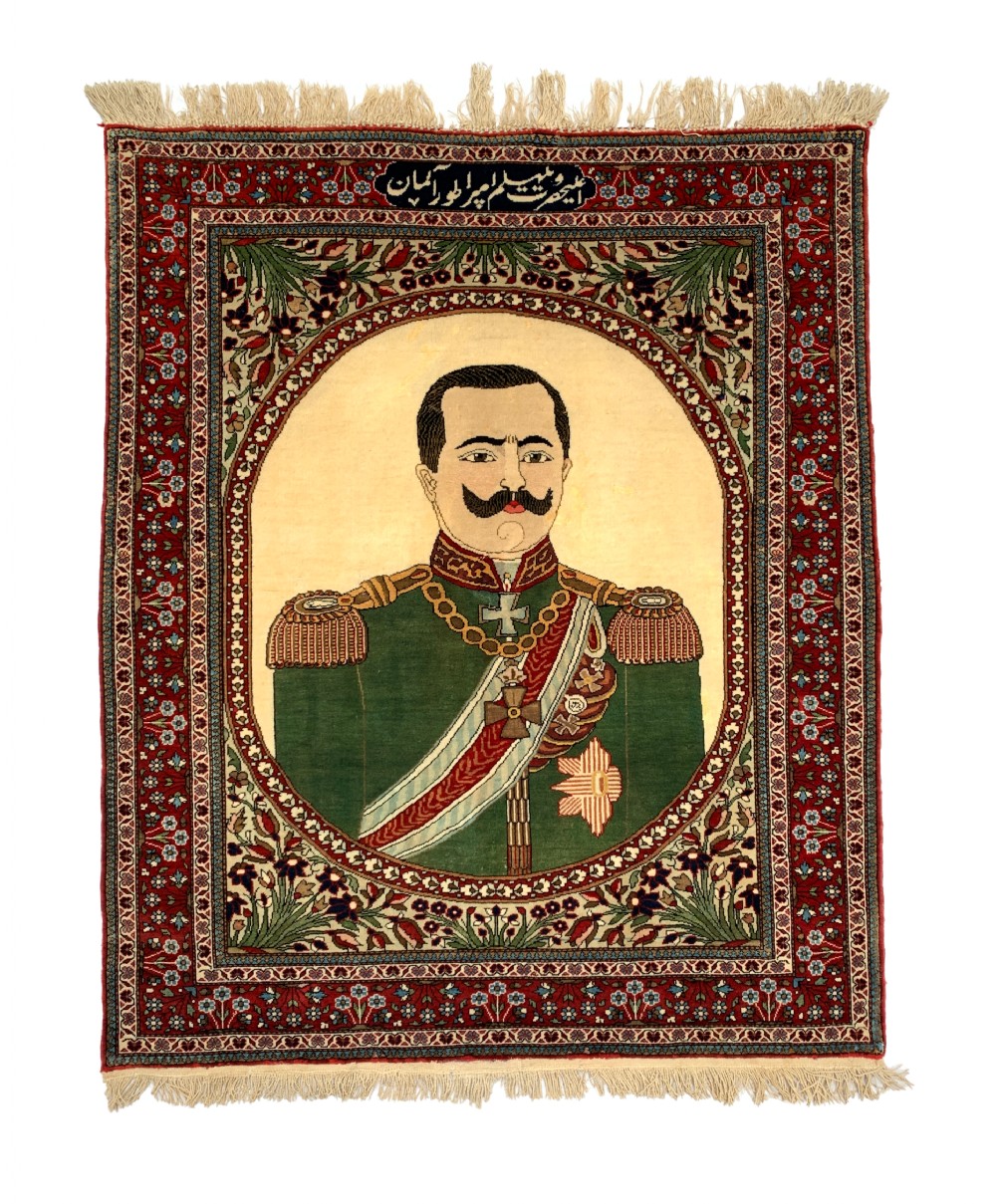 An antique Persian Mohtasham Kashan pictorial rug depicting Kaiser Wilhelm II in a military uniform within a oval medallion and floral borders.