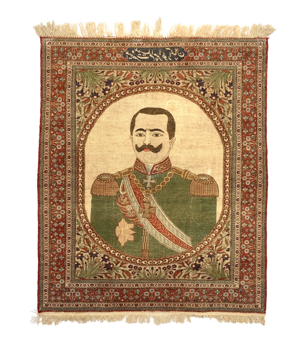 An antique Persian Mohtasham Kashan pictorial rug depicting Kaiser Wilhelm II in a military uniform within a oval medallion and floral borders. View II