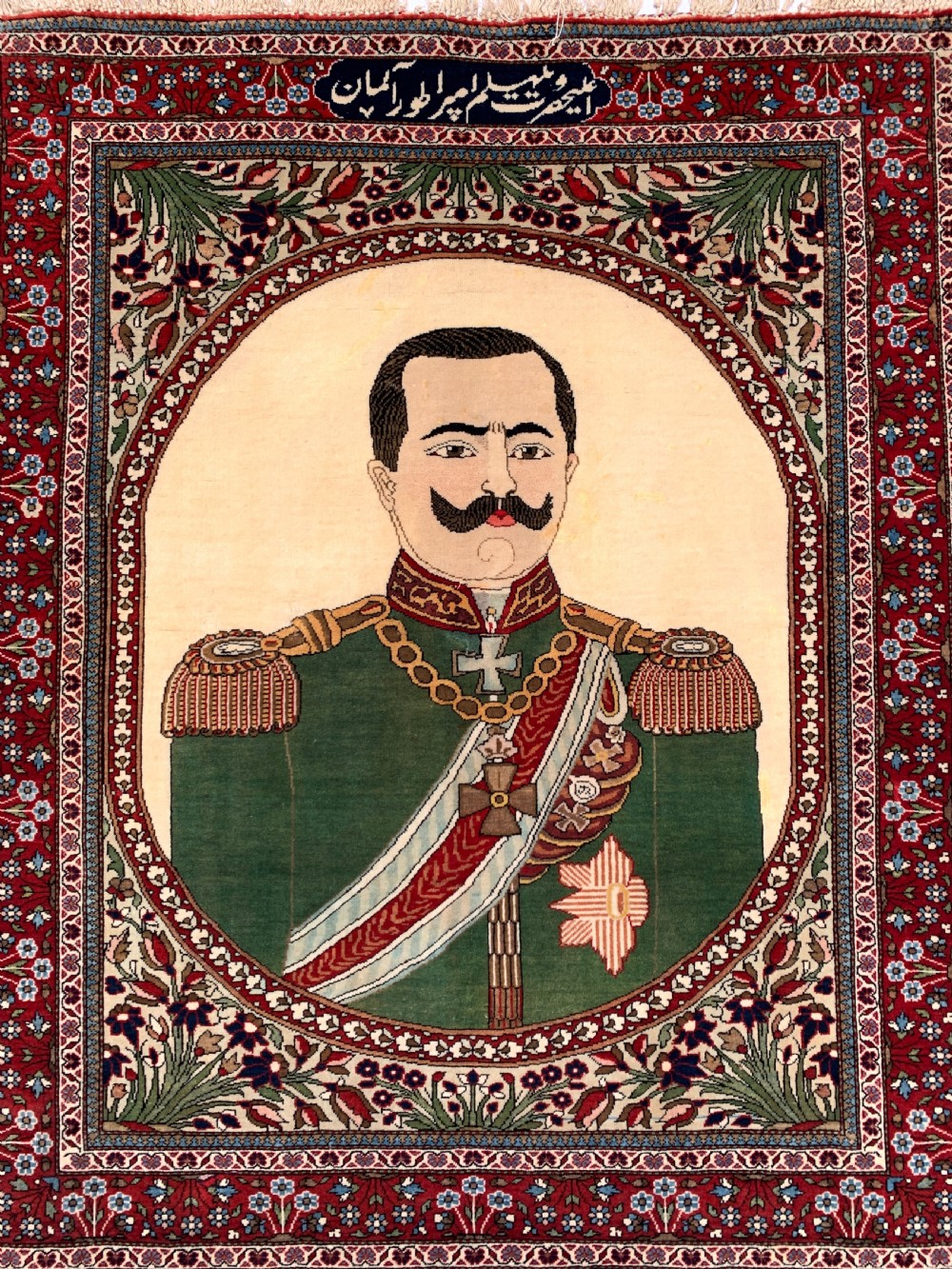 An antique Persian Mohtasham Kashan pictorial rug depicting Kaiser Wilhelm II in a military uniform within a oval medallion and floral borders. View III