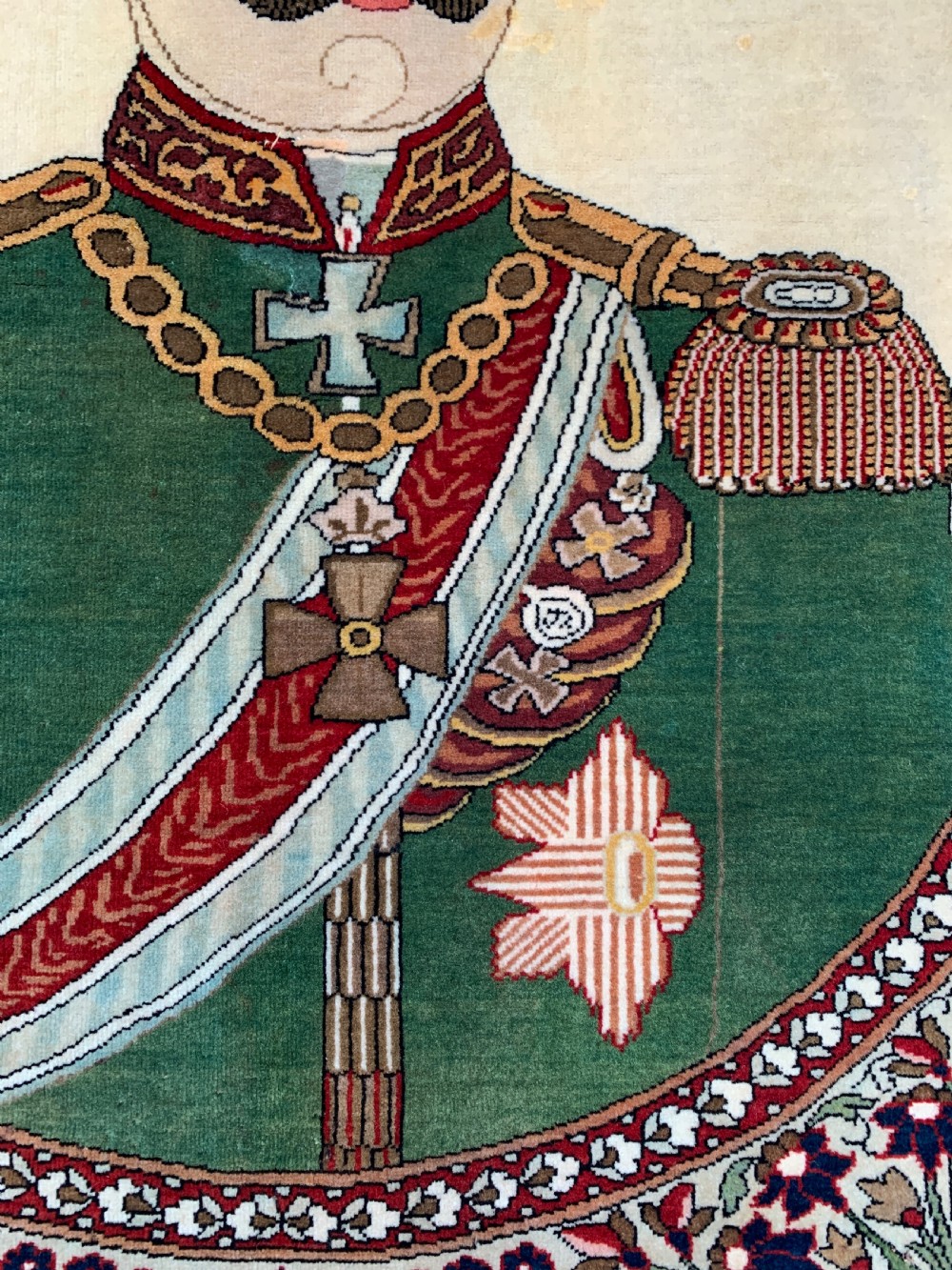 An antique Persian Mohtasham Kashan pictorial rug depicting Kaiser Wilhelm II in a military uniform within a oval medallion and floral borders. View IV