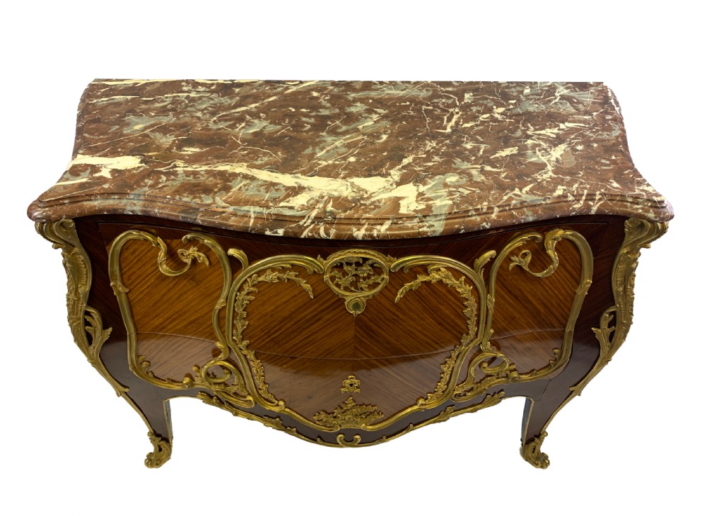 A French Louis XV style bombe commode featuring rich kingwood parquetry veneers, ornate gilt-bronze ormolu mounts, cabriole legs, and a shaped variegated marble top. View VIII