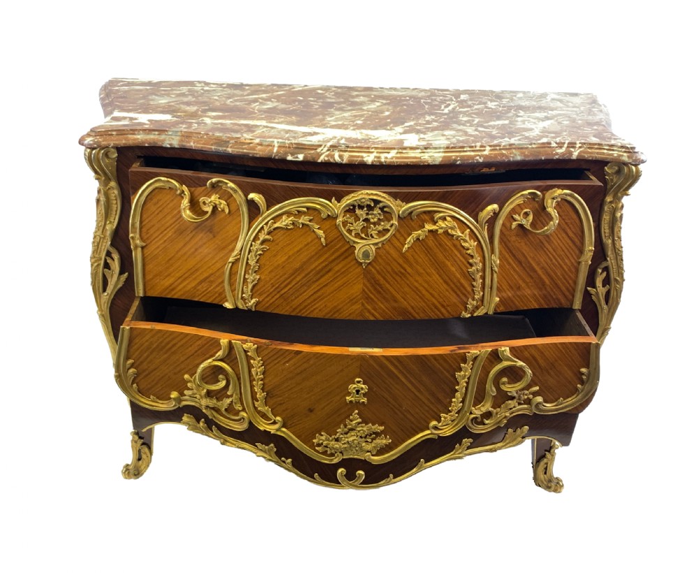 A French Louis XV style bombe commode featuring rich kingwood parquetry veneers, ornate gilt-bronze ormolu mounts, cabriole legs, and a shaped variegated marble top. View IX