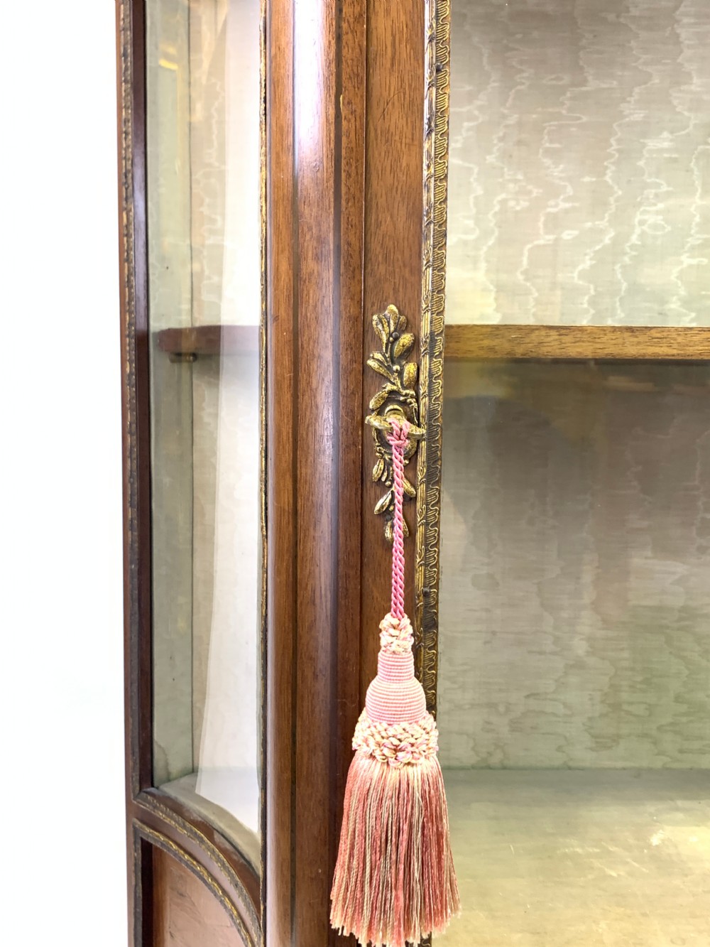 A French Louis XV style glazed vitrine featuring a contoured marble top, gilt-metal mounts, lower parquetry panels, and slender cabriole legs. View V