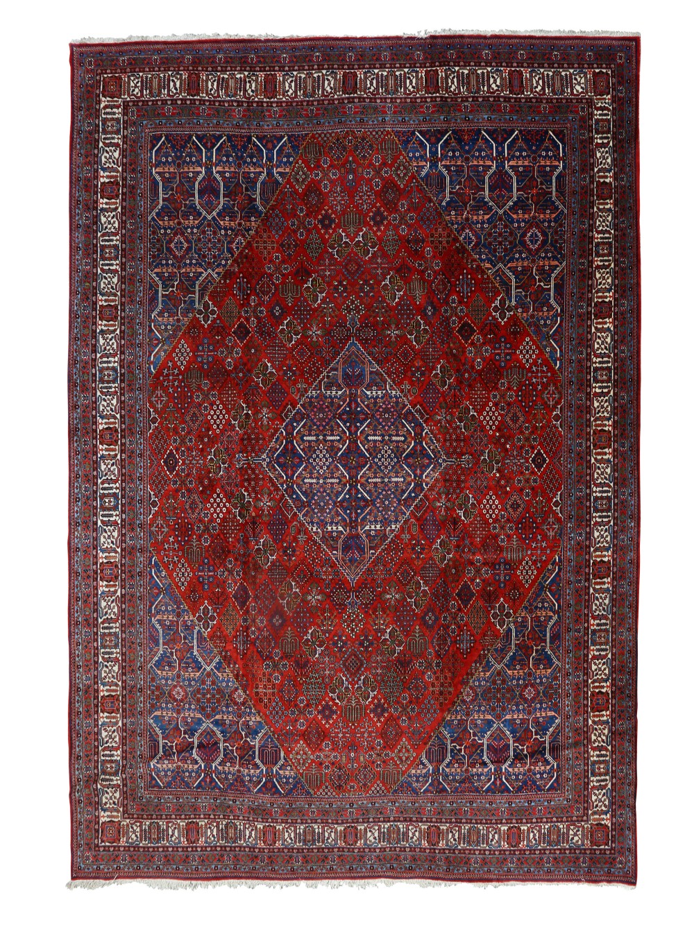 A large hand-knotted Persian Joshagan carpet featuring a central diamond medallion, intricate red geometric field, navy spandrels, and decorative borders.