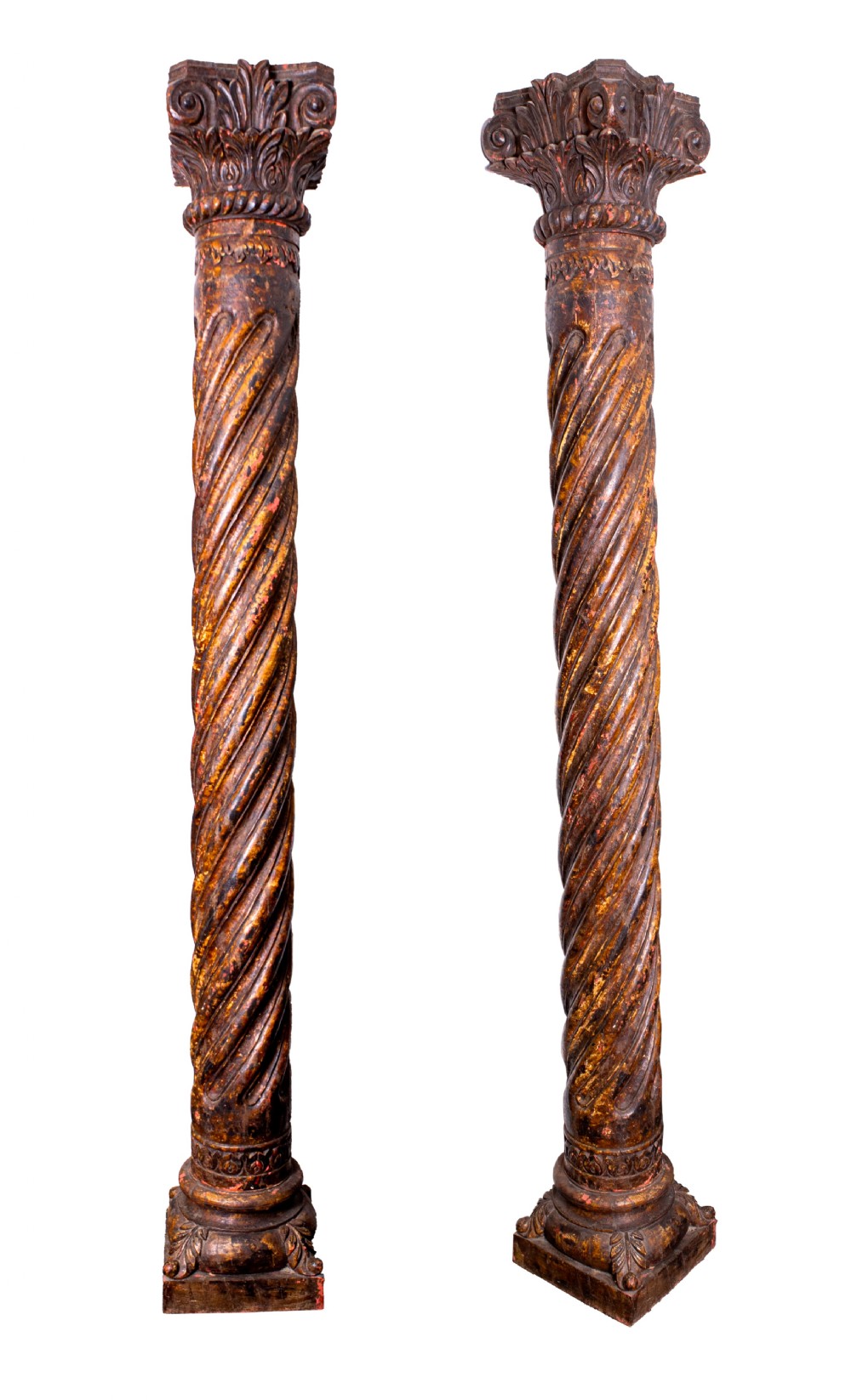A pair of 19th-century hand-carved dark wood columns featuring spiral twist shafts, ornate acanthus leaf capitals, and square bases.