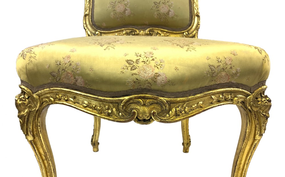 A pair of late 19th-century Rococo Revival giltwood side chairs upholstered in patterned green silk fabric with carved cabriole legs. View III