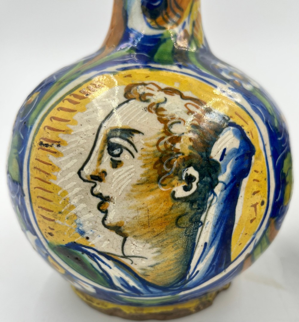 A pair of round 18th-century Italian maiolica ceramic vases painted in blue, yellow, and green with profile portrait medallions on bulbous bodies. View IV