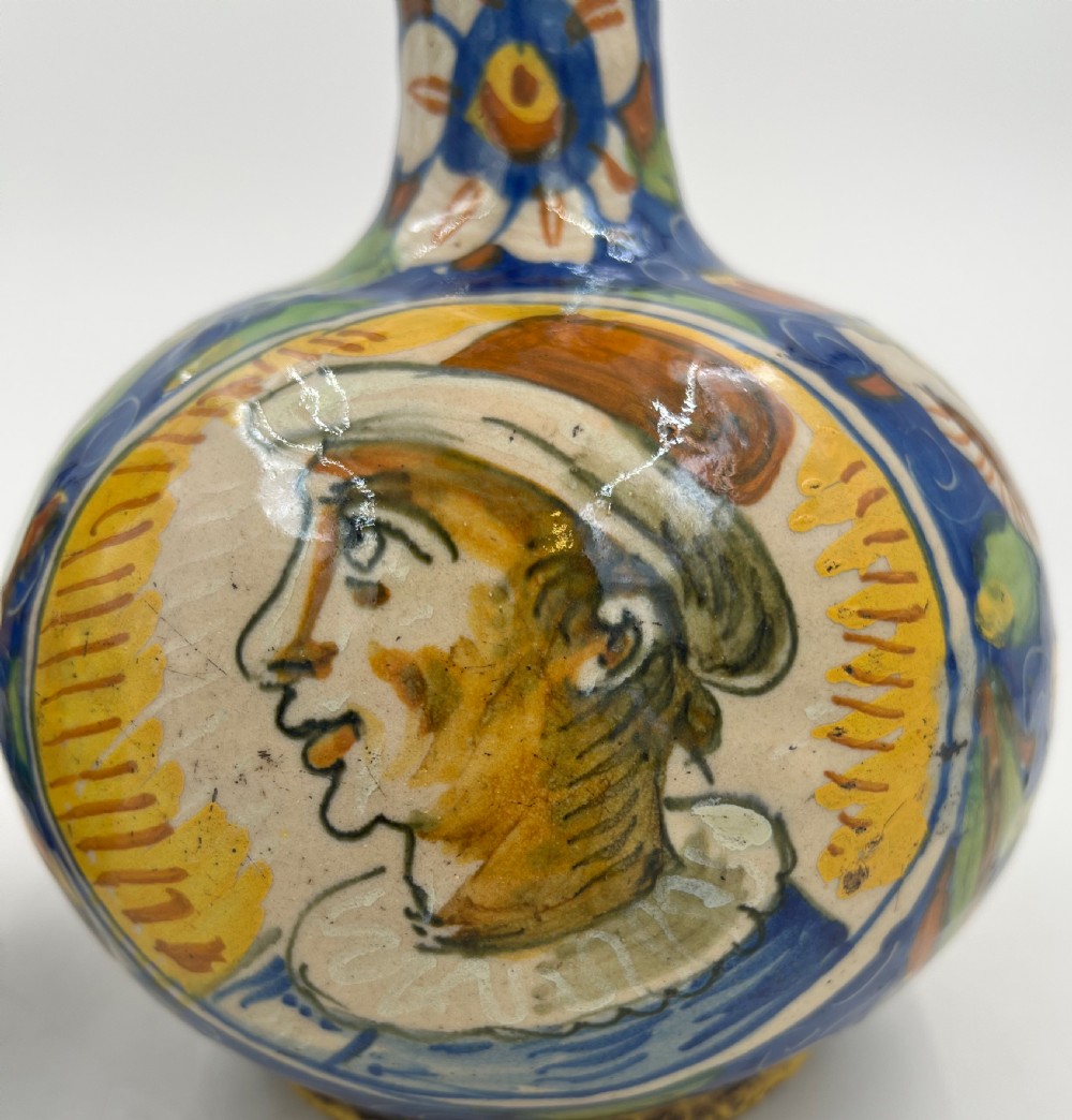 A pair of round 18th-century Italian maiolica ceramic vases painted in blue, yellow, and green with profile portrait medallions on bulbous bodies. View V