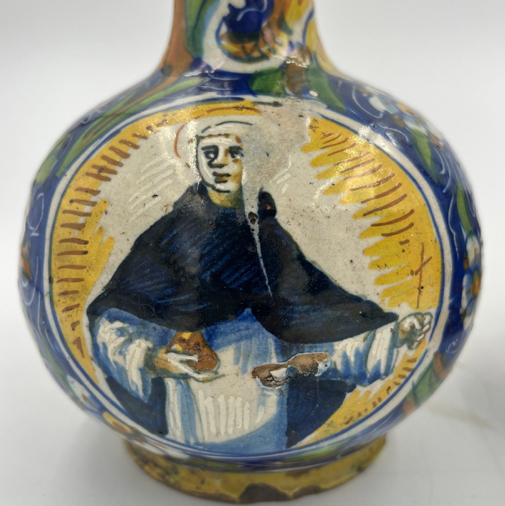 A pair of round 18th-century Italian maiolica ceramic vases painted in blue, yellow, and green with profile portrait medallions on bulbous bodies. View VI