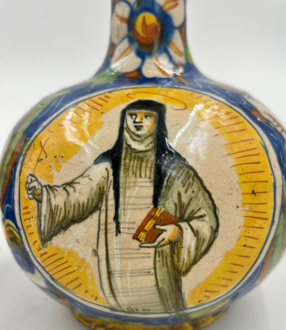 A pair of round 18th-century Italian maiolica ceramic vases painted in blue, yellow, and green with profile portrait medallions on bulbous bodies. View VII