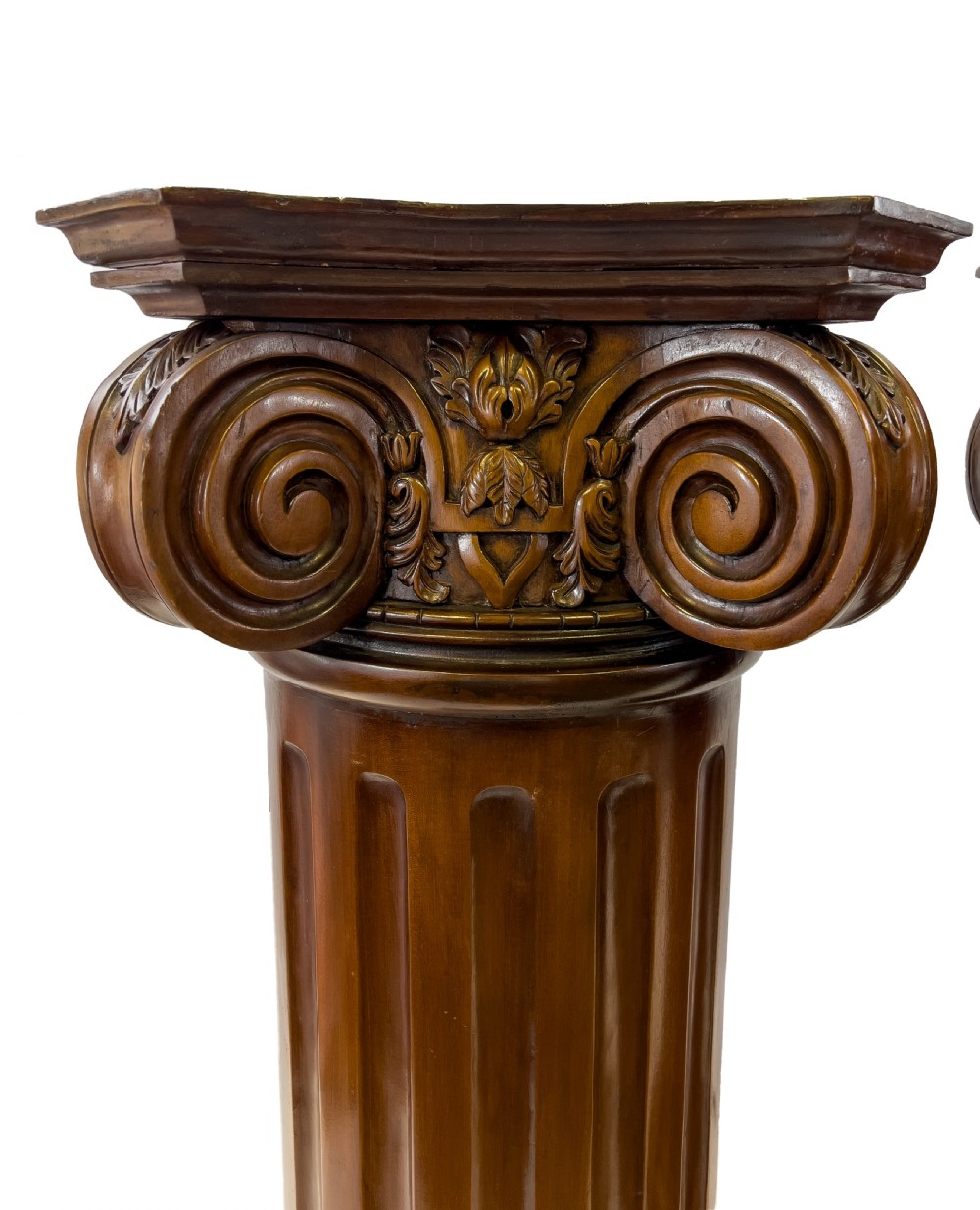 A pair of carved warm brown wooden pedestals styled as classical Ionic columns with fluted shafts and square bases. View IV