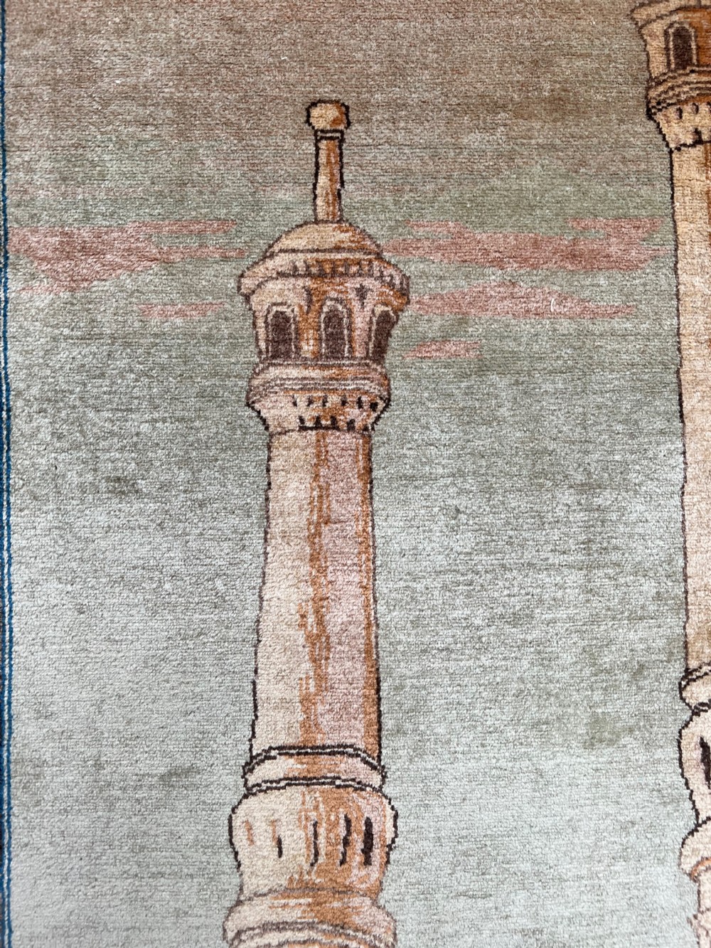A pair of matching hand-knotted wool Kashan rugs featuring architectural scenes with minarets, domes, Arabic calligraphy, and ornate floral borders. View IV