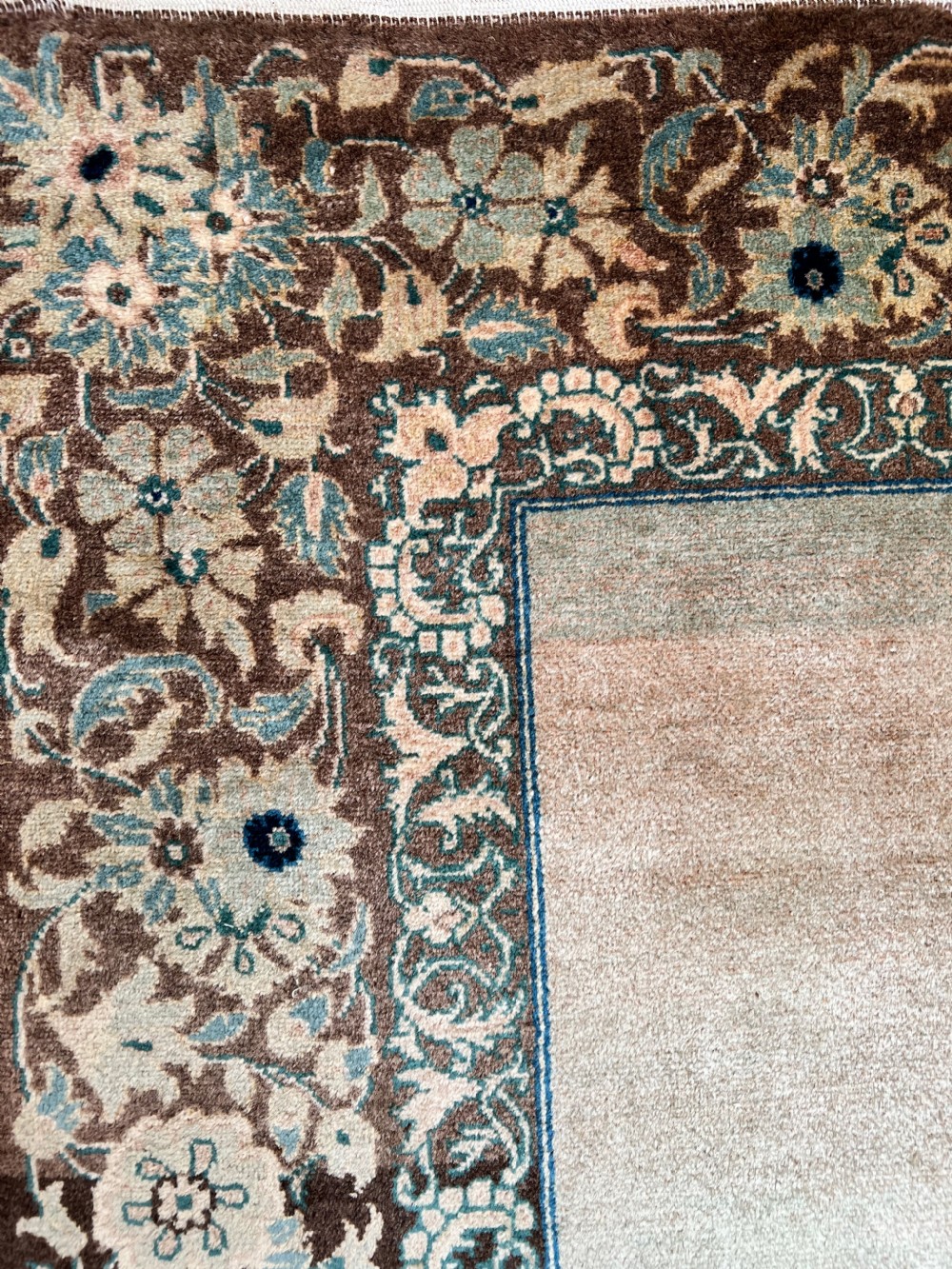 A pair of matching hand-knotted wool Kashan rugs featuring architectural scenes with minarets, domes, Arabic calligraphy, and ornate floral borders. View V