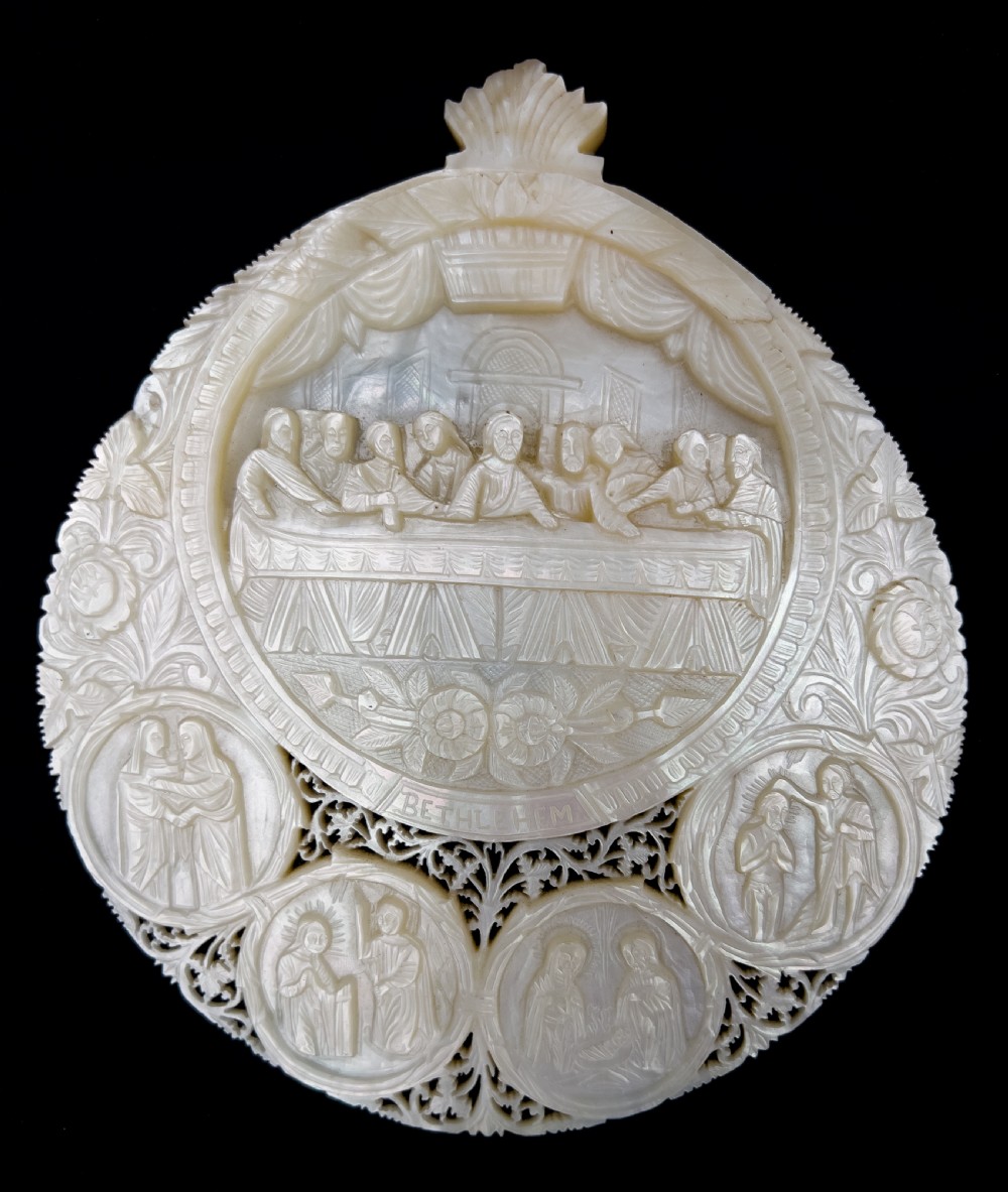 A set of five intricately hand-carved mother of pearl shells depicting biblical scenes with detailed pierced fretwork borders. View IV