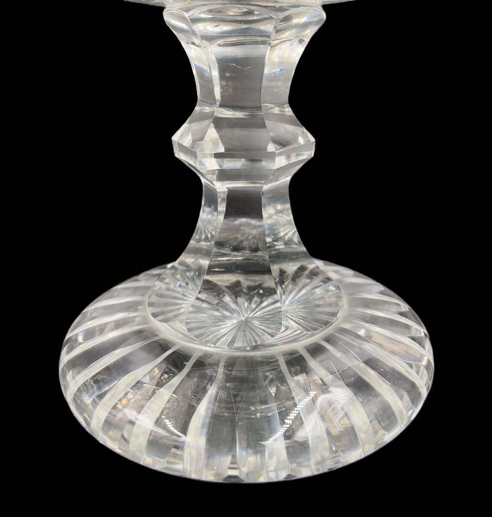 A pair of clear cut glass lidded urns featuring etched woodland motifs and faceted pedestal bases. View VI