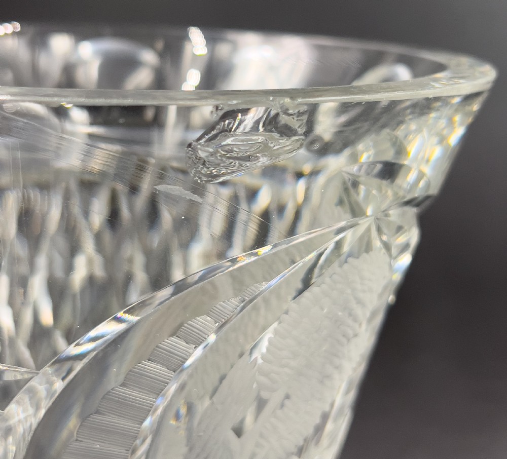 A pair of clear cut glass lidded urns featuring etched woodland motifs and faceted pedestal bases. View IX