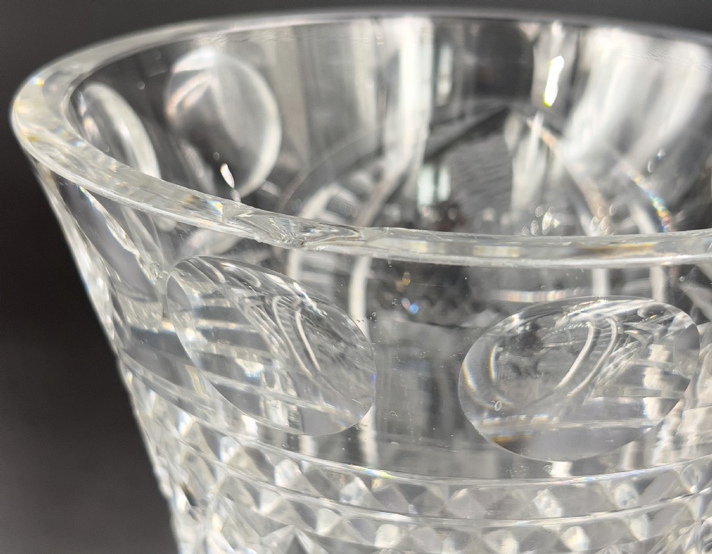 A pair of clear cut glass lidded urns featuring etched woodland motifs and faceted pedestal bases. View X
