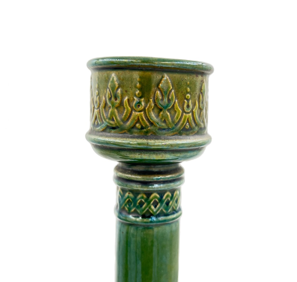 A pair of 19th-century Spanish Hispano-Moresque green glazed ceramic candlesticks featuring tall cylindrical necks, elaborate pierced scroll handles, and central circular relief medallions. View VII