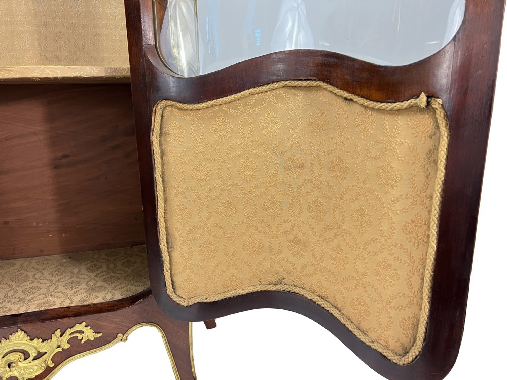A serpentine French Louis XV style vitrine cabinet featuring gilded ormolu mounts, glazed glass door, and a hand-painted Vernis Martin lower panel depicting romantic figures. View XIV