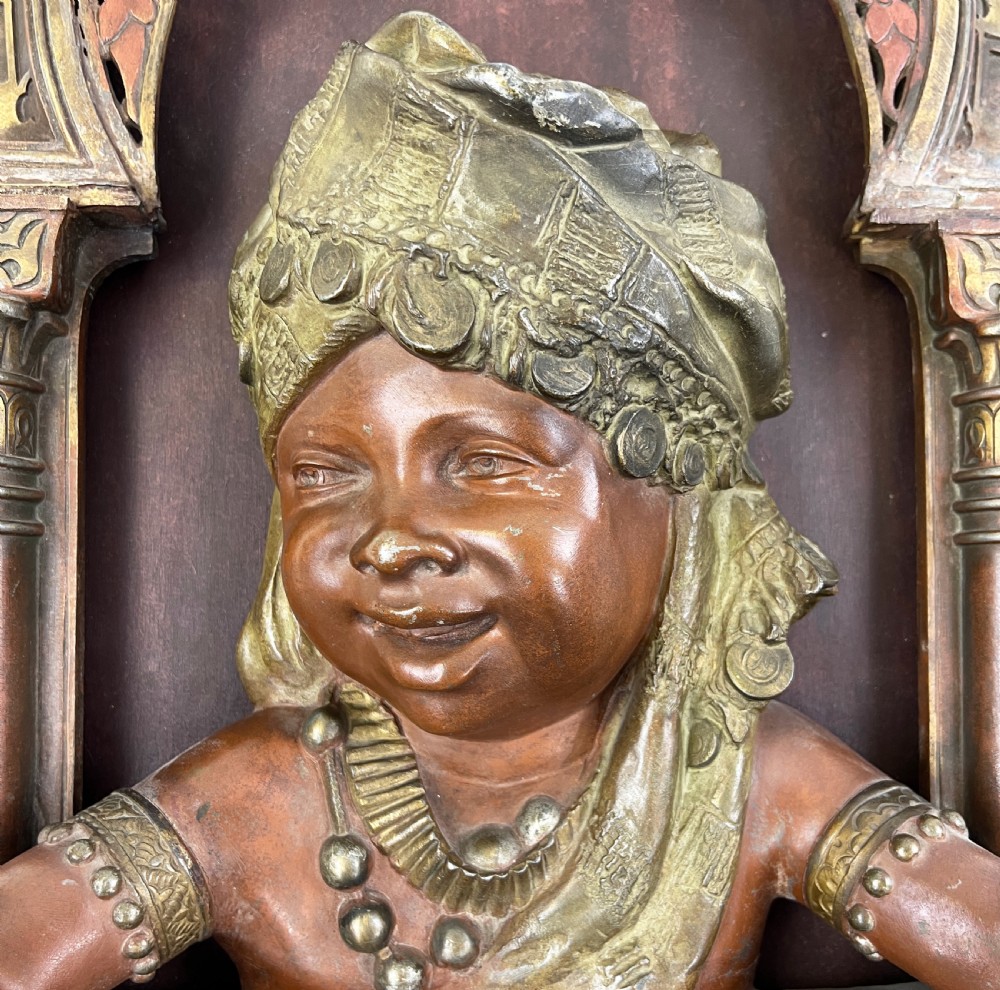 A late nineteenth-century patinated bronze wall light crafted in the Orientalist style, depicting a figure within a decorated Moorish arch. View II