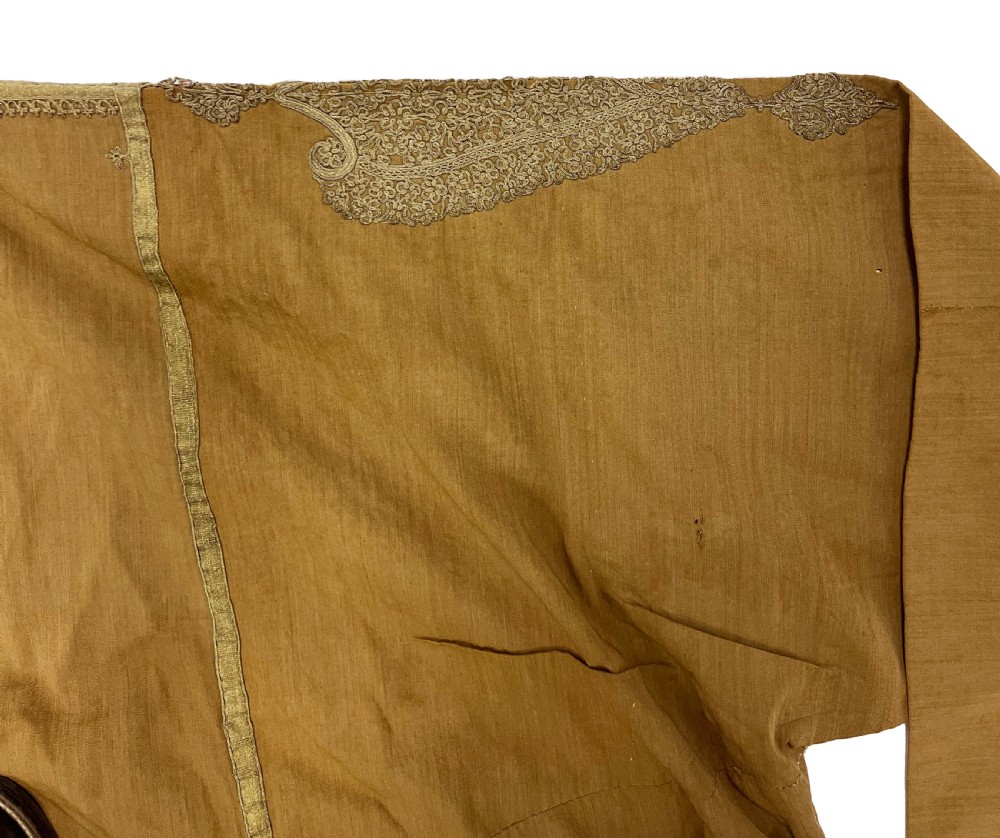 An antique ochre wool Persian Qajar robe featuring metallic thread embroidery around the neckline, shoulders, and cuffs. View V