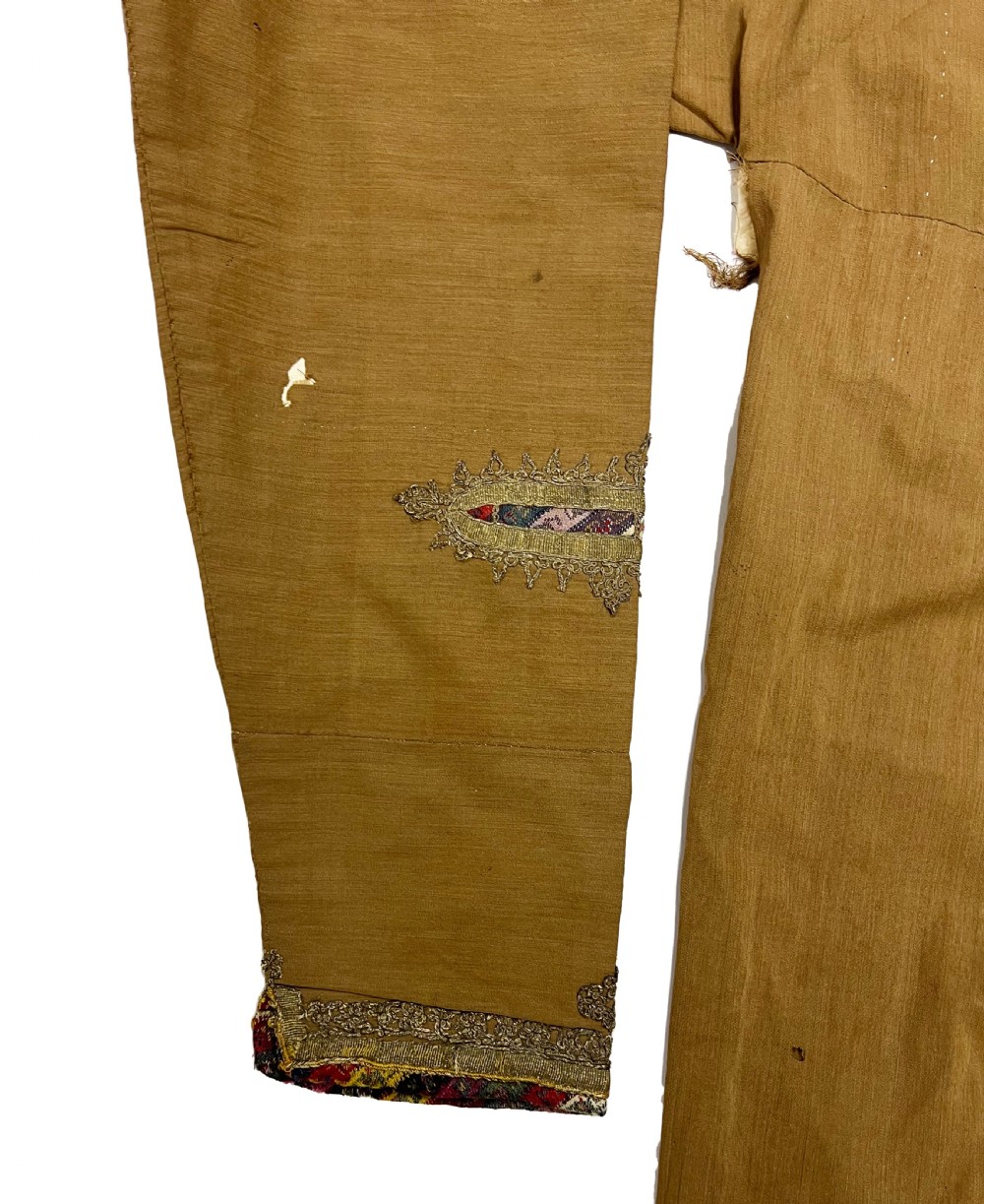 An antique ochre wool Persian Qajar robe featuring metallic thread embroidery around the neckline, shoulders, and cuffs. View VI