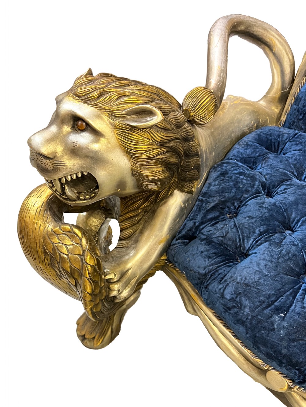 An ornate two-seater sofa featuring deep blue crushed velvet upholstery and a gilded wooden frame carved with a lion on one armrest and branch motifs on the other. View VII