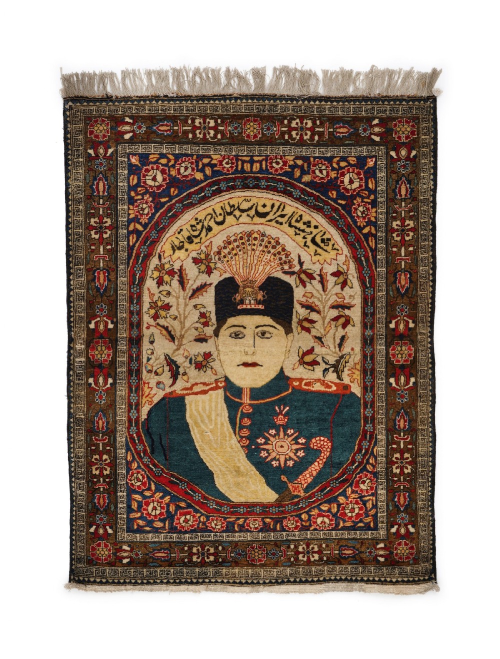 A hand-knotted Persian rug featuring an oval central portrait of Ahmad Shah Qajar framed by calligraphy and intricate floral borders in navy blue, terracotta, and ivory.